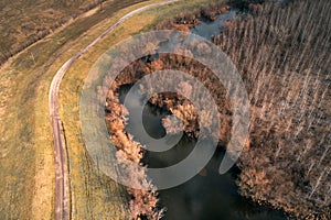 Aerial view of river Tisza oxbow meander and old winding road from drone pov