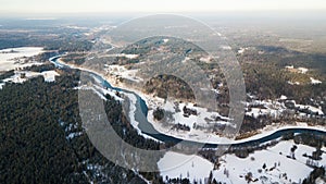 Aerial view of river Venta and forests on a snowy winter day photo