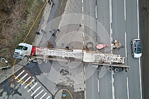 Aerial view of road accident with overturned truck blocking traffic