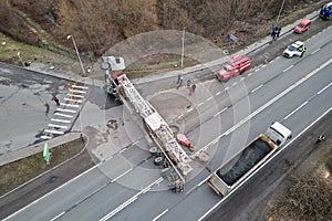 Aerial view of road accident with overturned truck blocking traffic