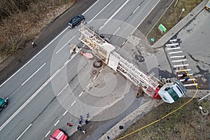 Aerial view of road accident with overturned truck blocking traffic