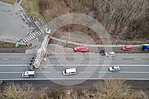 Aerial view of road accident with overturned truck blocking traffic