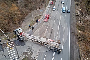 Aerial view of road accident with overturned truck blocking traffic