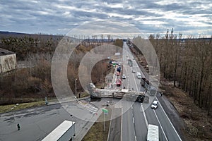 Aerial view of road accident with overturned truck blocking traffic