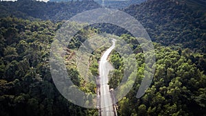 An aerial view of the road across the rainforest mountains in Hulu Selangor, Malaysia