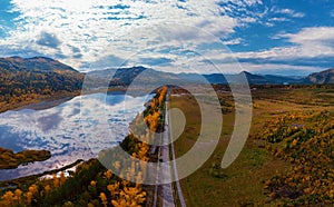 Aerial view of road in beautiful autumn Altai forest