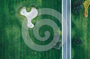 Aerial view of road through beautiful green field