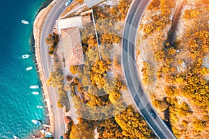 Aerial view of road and boats in the sea at sunset in autumn