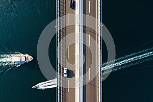 Aerial view on road. Bridge above sea. View from a drone. Natural landscape in summer time from air. Travel and vacation. Transpor