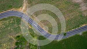 Aerial view road curve construction. Aerial above view of a rural landscape with a curvy road running through. Aerial view of curv