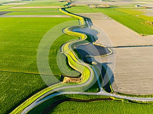 An aerial view of a road with curves. Road through the field. Image for wallpaper, background, design