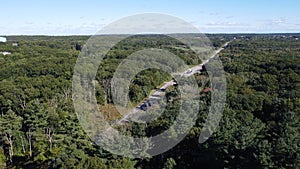 Aerial view of a road through a dense forest in Smithfield, Rhode Island