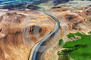 Aerial view on road in Iceland. Aerial landscape above highway in the geysers valley. Icelandic landscape from air. Famous place.