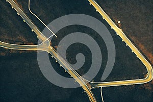 Aerial view of road interchange or highway intersection with busy urban speeding traffic abstract background. Junction