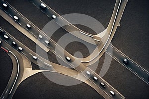 Aerial view of road interchange or highway intersection with busy urban speeding traffic abstract background. Junction