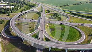 Aerial view of road interchange or highway intersection with busy urban traffic