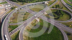 Aerial view of road interchange or highway intersection with busy urban traffic