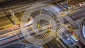 Aerial view of a road intersection in a big city night timelapse.