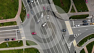 Aerial view of road junction or road intersection in city with cars turning left and righ