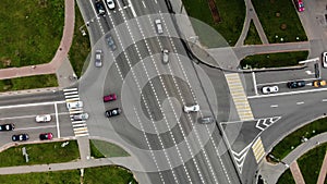 Aerial view of road junction or road intersection in city with cars turning left and righ