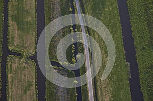 Aerial view of road leading through peat excavation meadow landscape in the netherlands