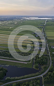 Aerial view of road leading through peat excavation meadow landscape in the netherlands
