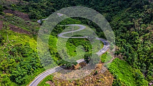 Aerial view road in mountains, Road running through green hills forest with car