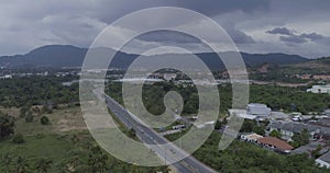 Aerial view of road and palm trees with mountains and sky backround in Kathu, Phuket