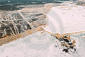 Aerial View Of Road Through Ponds In Winter Snowy Landscape. Frozen Ponds Of Fisheries In South Of Belarus. Top View Of