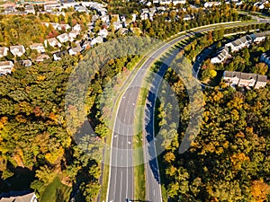 Aerial view of a road among residential areas of a small town in autumn