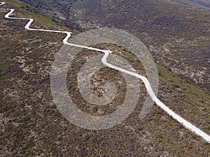 Aerial view of road to the Ecological Park Joya la Barreta, a long winding road