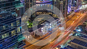 Aerial view on Dubai Marina skyscrapers and the most luxury yacht in harbor night timelapse, Dubai, United Arab Emirates