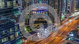 Aerial view on Dubai Marina skyscrapers and the most luxury yacht in harbor night timelapse, Dubai, United Arab Emirates