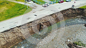 Aerial view road in the village which was destroyed by a flood on the river. The asphalt road which was washed away by