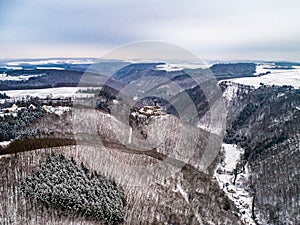 aerial view rock with medieval castle Ehrenburg near moselle river Brodenbach white winter snow wonderland forest hills