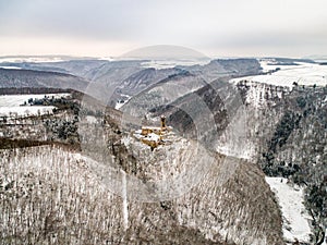 aerial view rock with medieval castle Ehrenburg near moselle river Brodenbach white winter snow wonderland forest hills