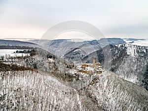 aerial view rock with medieval castle Ehrenburg near moselle river Brodenbach white winter snow wonderland forest hills