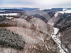 aerial view rock with medieval castle Ehrenburg near moselle river Brodenbach white winter snow wonderland forest hills