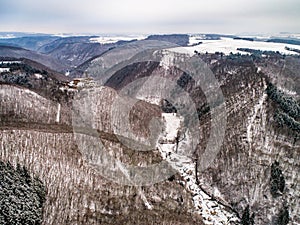 aerial view rock with medieval castle Ehrenburg near moselle river Brodenbach white winter snow wonderland forest hills