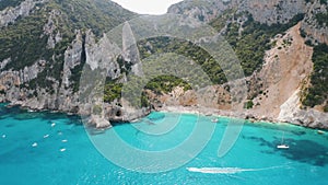 Aerial view of rocks, mountains, blue sea, beach, boats in summer