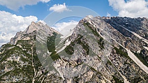 Aerial view of the rocks with mudflow and snow high in the Alpine mountains