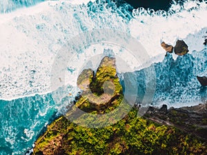 Aerial view with rocks and ocean with big waves