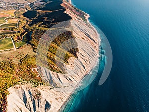 Aerial view of cliff, coastline and blue sea with waves