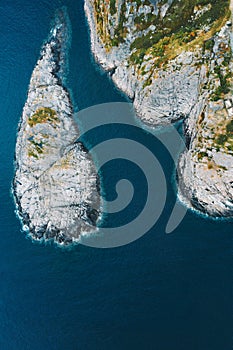 Aerial view rocky island and blue sea drone landscape in Norway