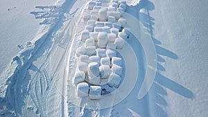 An aerial view of the rolls of hays on the ground in Finland