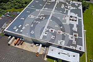 Aerial view rooftop on the solar panel energy for generating electricity with of building warehouse an industrial zone