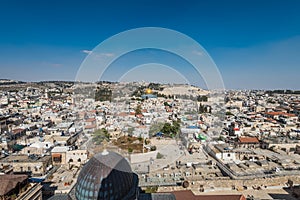 Aerial view of rooftops of the old city of Islamic quarter with blue sky of Jerusalem, with Golden Dome of Rock and Mount of