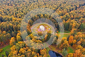 Aerial view of Round Hall building in Pavlovsky Park among the autumn trees, neighborhood of Saint-Petersburg