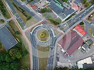 Aerial view on roundabout intersection with cars traffic and railroad