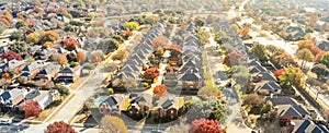 Aerial view row of new house with cul-de-sac dead-end and bright orange color fall foliage near Dallas